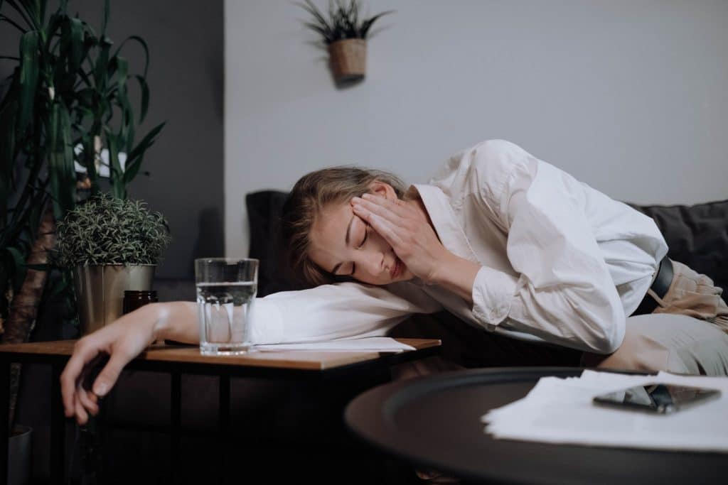 Exhausted Woman Falling Asleep On Table