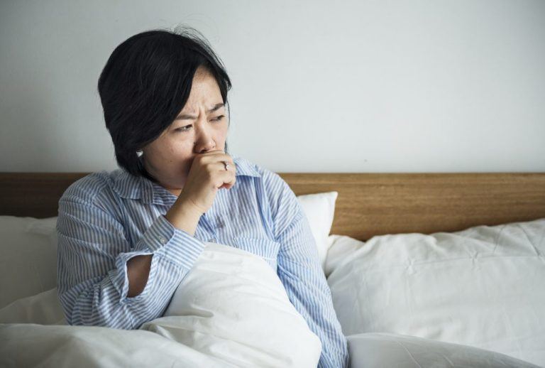 Woman Coughing Laying In Bed