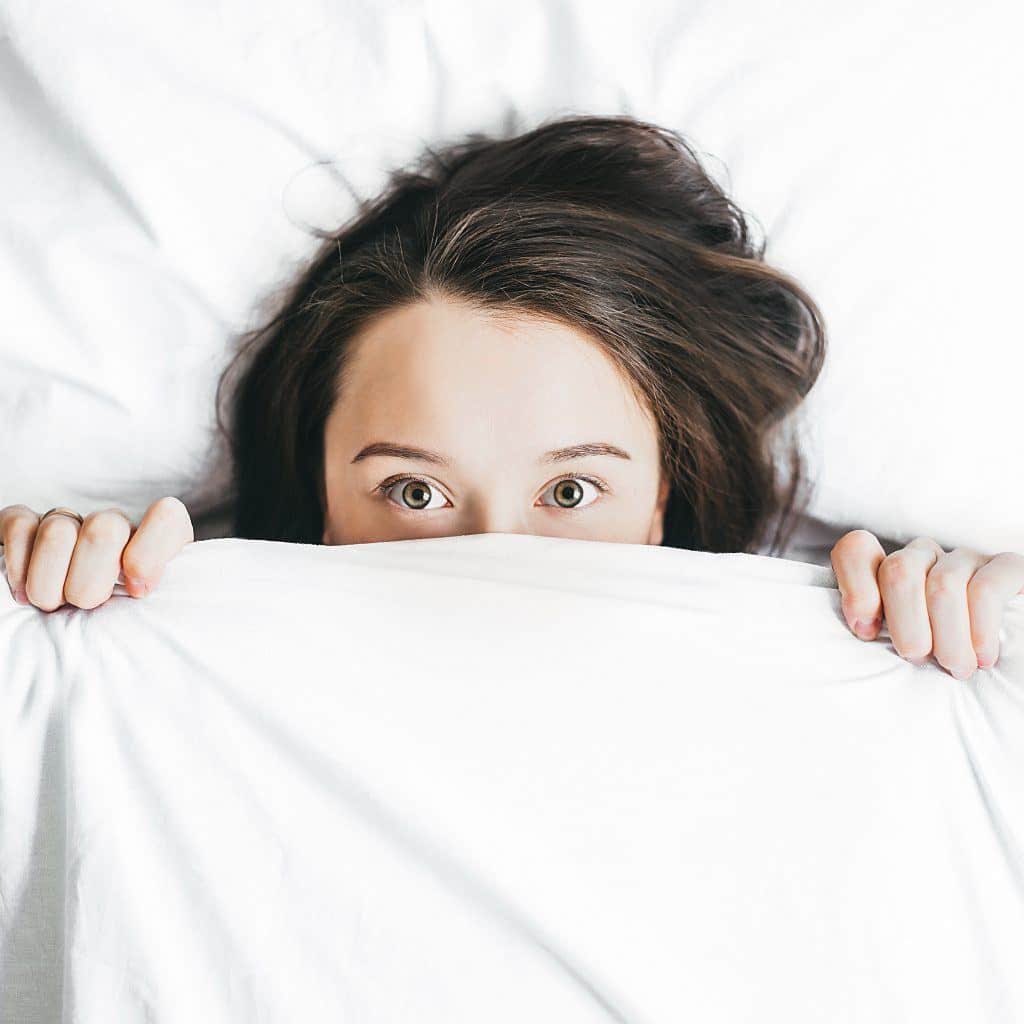 Woman Hiding Under White Sheet, Eyes Peeking