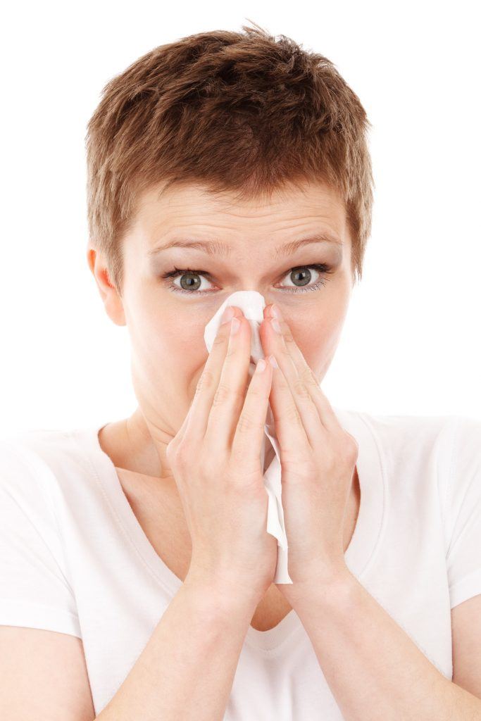 Woman Blowing Nose Due To Allergies