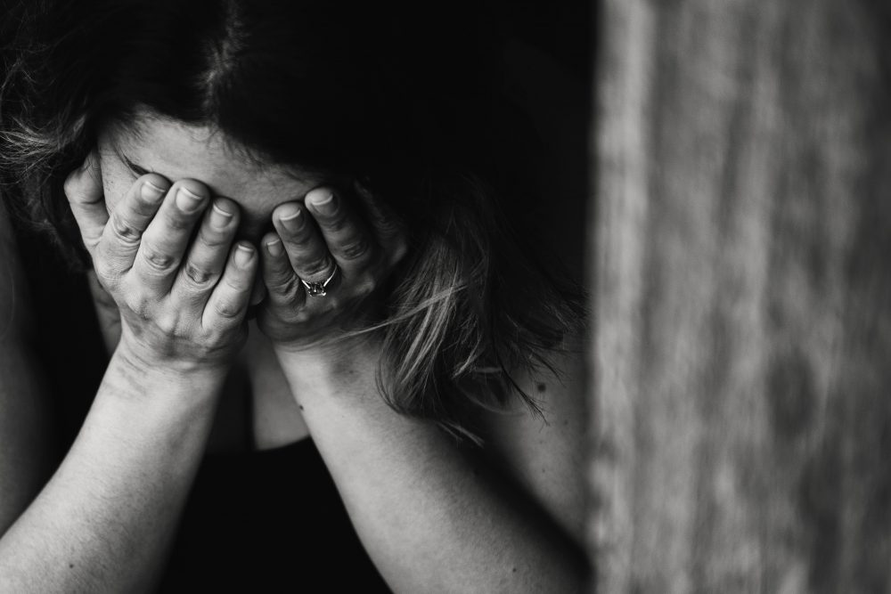 Woman Sad Or Distressed, Closing Eyes With Hands, Black And White Image