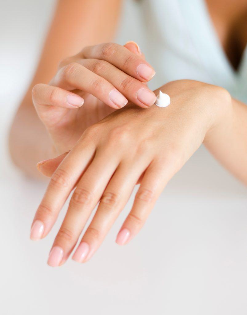 Woman Applying Body Lotion To Hand