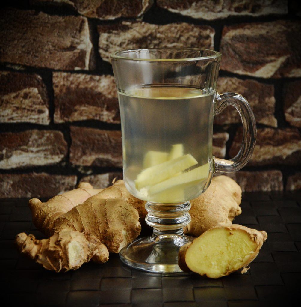 Ginger Root In Hot Water, And Laying On Table