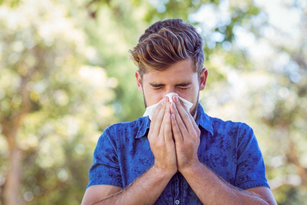 Handsome Hipster Blowing His Nose On A Sunny Day Pc3Gcmg 1024X683 1 - Essential Oils For Allergies