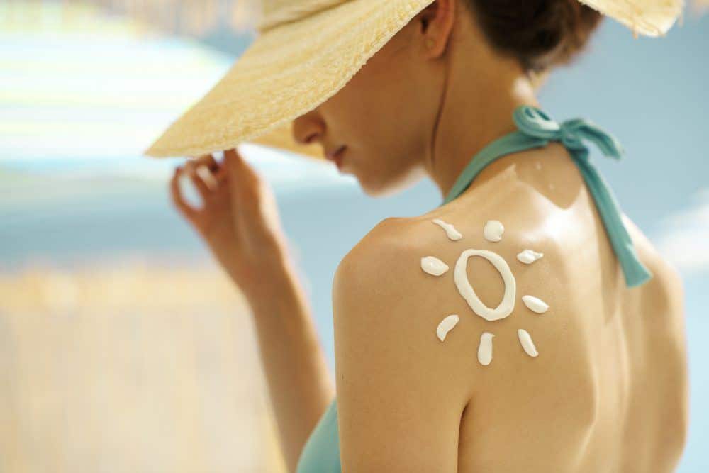 Woman Tanning At The Beach With Sunscreen Cream 4Ltd5Yx E1575999350354 - Carrot Seed Essential Oil